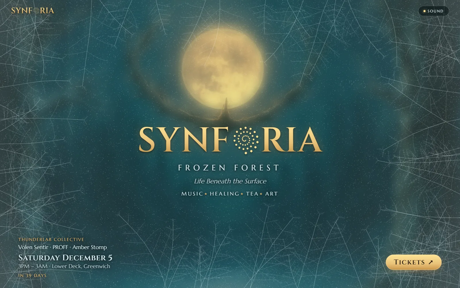 SYNFORIA: Frozen Forest — The front page of their whole site behind a frozen window: frost keeps creeping back over the glass, every bar a breath clears it round the moon, and by the tickets the window has thawed.